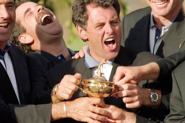 Bernard Gallacher, centre, and Sam Torrance get their hands on the Ryder Cup at Oak Hill in 1995. Picture: Getty