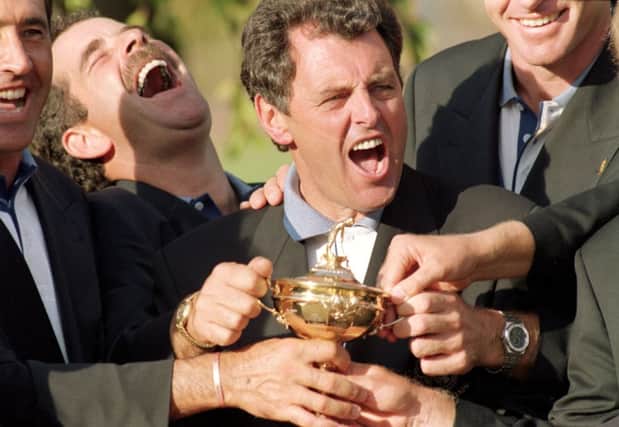 Bernard Gallacher, centre, and Sam Torrance get their hands on the Ryder Cup at Oak Hill in 1995. Picture: Getty