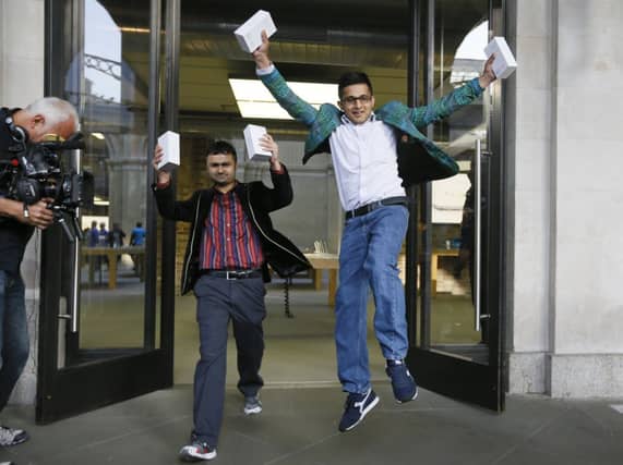 Sam Sheikh, left, and Jameel Ahmed with their new iPhones. Picture: AP
