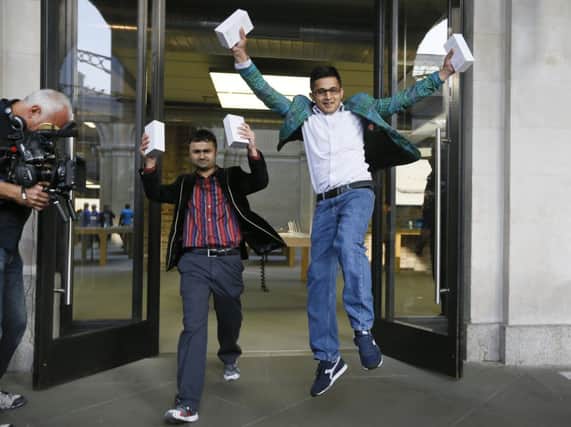 Sam Sheikh, left, and Jameel Ahmed with their new iPhones. Picture: AP