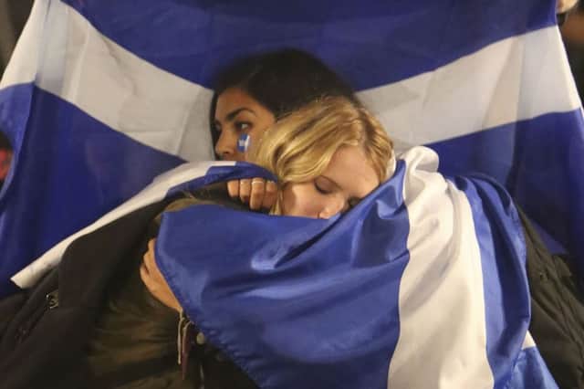 Yes campaigners comfort each other after learning of Nos victory. Picture: Mick McGurk