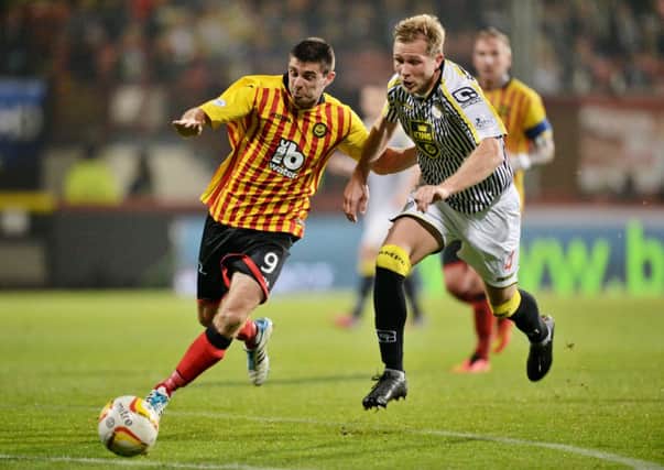Partick goalscorer Kris Doolan tries to shake off Marc McAusland (right). Pic: SNS