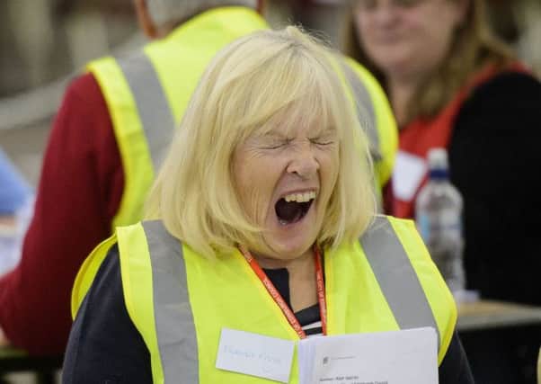 Woman shows signs of fatigue as she counts ballot cards. Picture: Getty