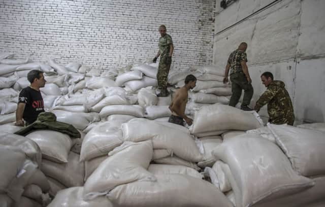 Sacks from a Russian convoy carrying humanitarian aid in Donetsk yesterday. Picture: Reuters