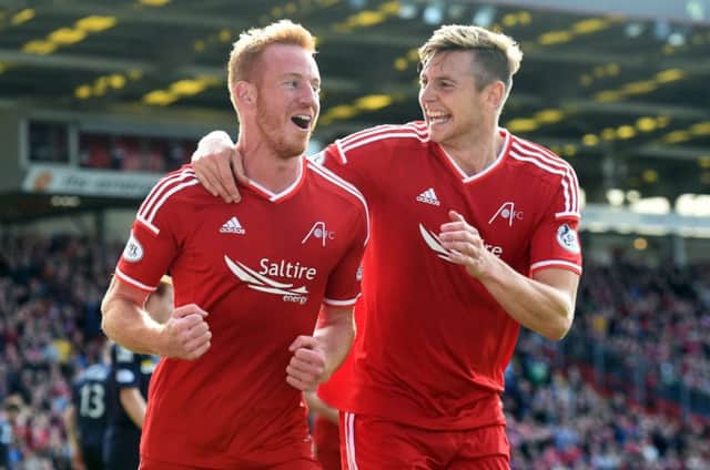 Aberdeen's Ash Taylor (right) celebrates with goal scorer Adam Rooney. Picture: SNS