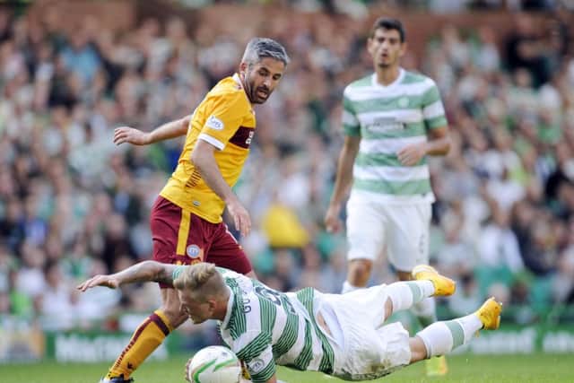 Motherwell's Keith Lasley and Celtic's John Guidetti clash. Picture: PA
