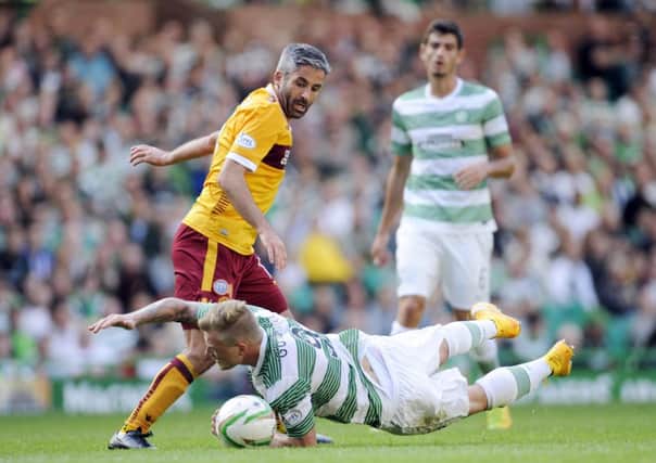 Motherwell's Keith Lasley and Celtic's John Guidetti clash. Picture: PA