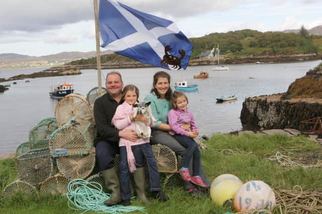 Ian McWhinney and wife Jess with their daughters 'rule the independent kingdom of Islonia. Picture: Peter Jolly