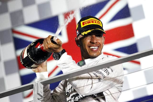 Lewis Hamilton sprays champagne on the podium following his win. Picture: Reuters