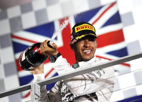 Lewis Hamilton sprays champagne on the podium following his win. Picture: Reuters