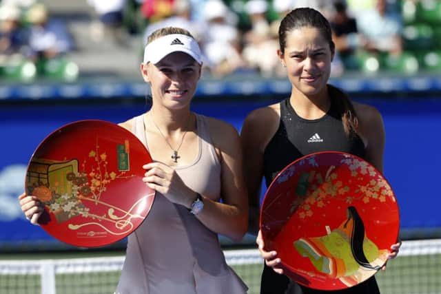 Ana Ivanovic, right, and Caroline Wozniacki pose with their trophies in Tokyo. Picture: AP