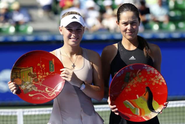 Ana Ivanovic, right, and Caroline Wozniacki pose with their trophies in Tokyo. Picture: AP