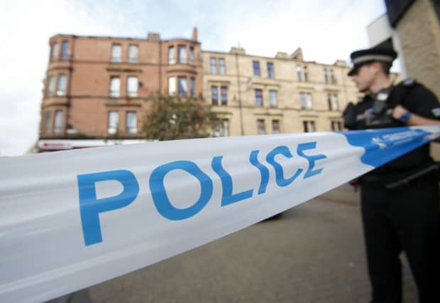 An police officer near to the scene in Boyd Street. Picture: PA
