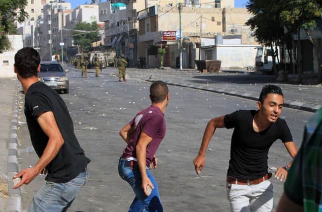 Palestinians clash with Israeli security forces near the building where two suspects were killed. Picture: AFP