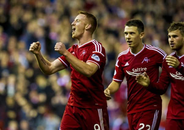 Aberdeen's Adam Rooney (left) celebrates with team-mates. Picture: SNS