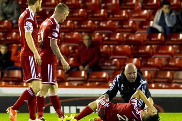 Aberdeen's Ryan Jack writhes on the floor in agony. Picture: SNS