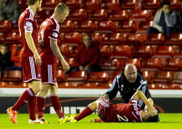 Aberdeen's Ryan Jack writhes on the floor in agony. Picture: SNS