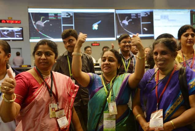 Staff from the Indian Space Research Organisation celebrate the successful Mars mission. Picture: Getty