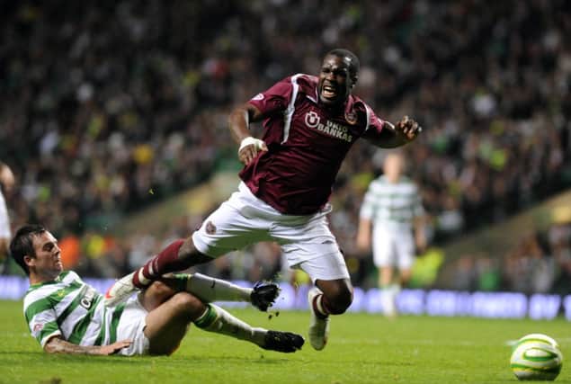 Celtic's Danny Fox brings down Hearts Christian Nade. Picture: Ian Rutherford