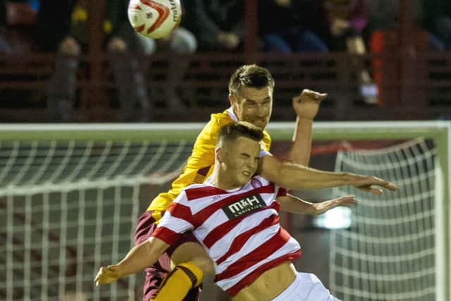 Motherwell's Steven McManus challenges Eamonn Brophy. Picture: SNS