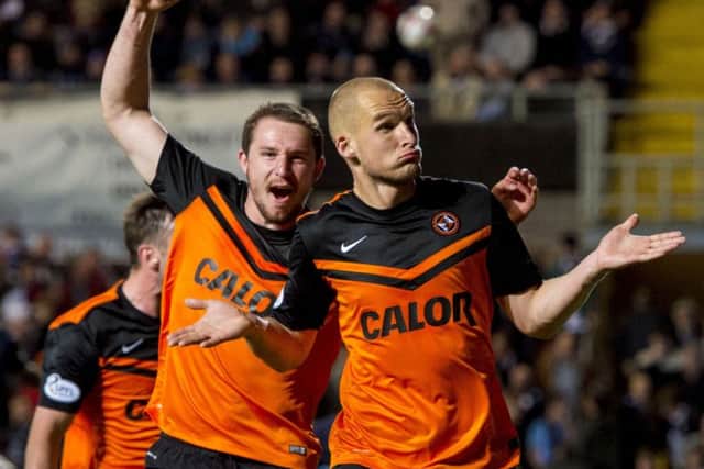 Uniteds Jaroslaw Fojut, right, celebrates after his late headed winner in the Dundee derby. Picture: SNS
