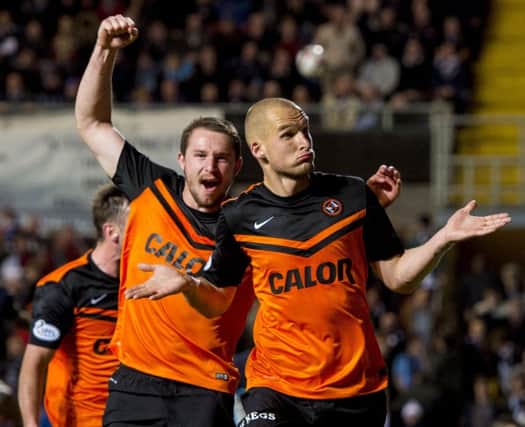 Uniteds Jaroslaw Fojut, right, celebrates after his late headed winner in the Dundee derby. Picture: SNS