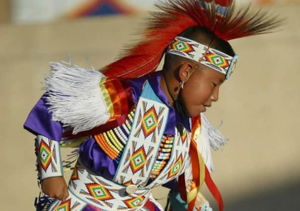 A young Navajo in tribal costume. Inset president Obama. Picture: Getty