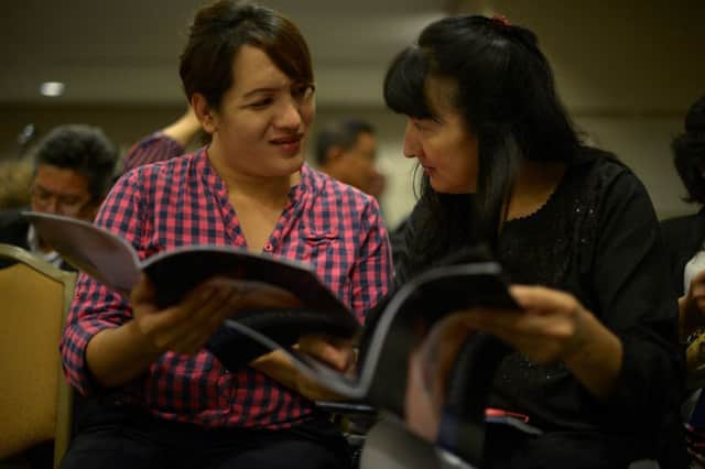 Transgender women read the Human Rights Watch report in the Malaysian capital Kuala Lumpur yesterday. Picture: Getty