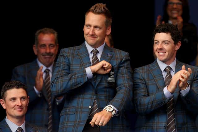 Ian Poulter acknowledges the crowd alongside Justin Rose and Rory McIlroy at the opening ceremony. Picture: Getty