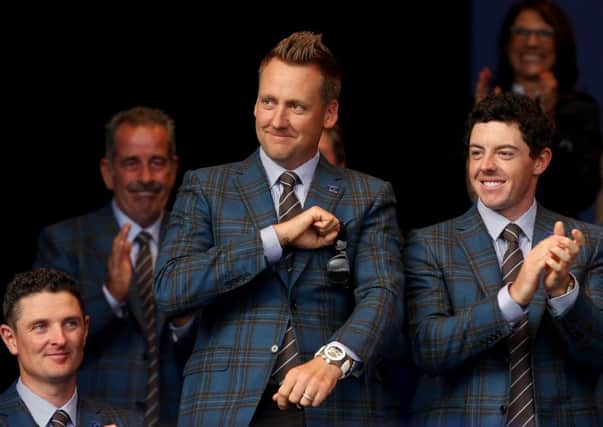 Ian Poulter acknowledges the crowd alongside Justin Rose and Rory McIlroy at the opening ceremony. Picture: Getty