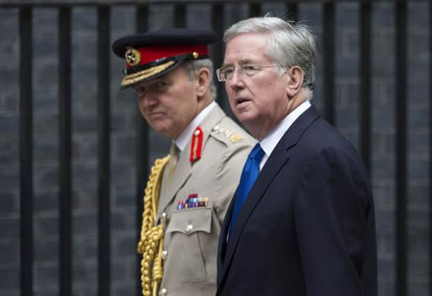 Secretary of Defence Michael Fallon, right, and Chief of the Defence Staff General Sir Nicholas Houghton arrive at Downing Street. Picture: Getty