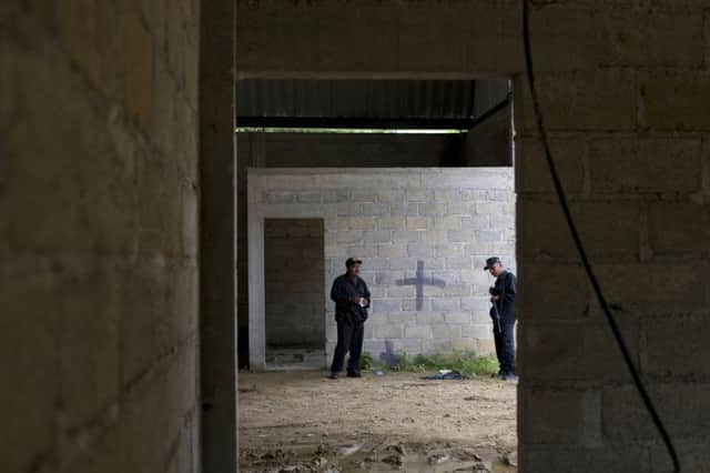 Black cross marks spot where alleged drug gang member was gunned down. Picture: AP