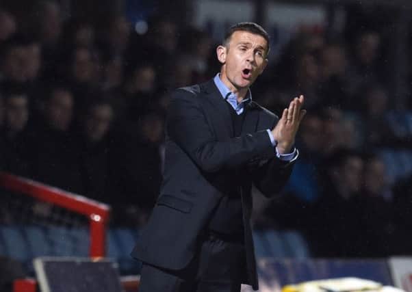 Ross County manager Jim McIntyre gives out instructions from the dugout. Picture: SNS