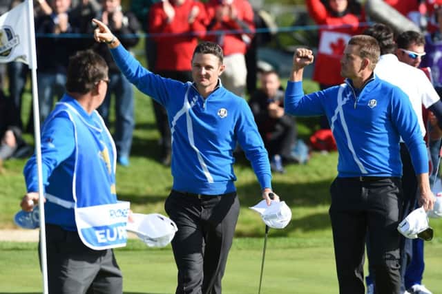 Justin Rose and Henrik Stenson celebrate on the 14th green after winning their match against Bubba Watson and Webb Simpson. Picture: Ian Rutherford