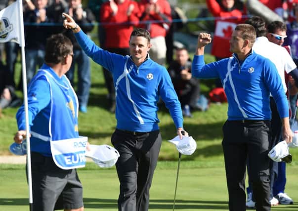 Justin Rose and Henrik Stenson celebrate on the 14th green after winning their match against Bubba Watson and Webb Simpson. 
Picture: Ian Rutherford
