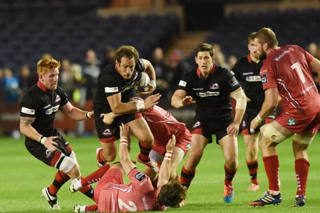 Edinburgh's Andries Struass escapes counterpart Rhodri Williams (ground). Picture: SNS