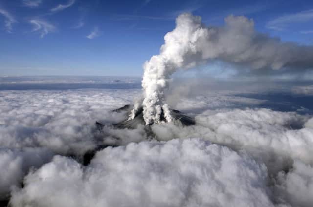 Dense white plumes rise high in the air as Mt. Ontake erupts in central Japan. Picture: AP/Kyodo News