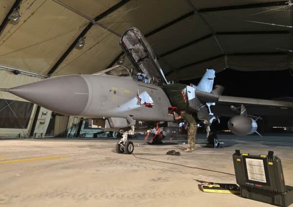 A Tornado GR4 is armed with Paveway missiles at RAF Akrotiri in Cyprus before leaving for a combat mission over Iraq. Picture: AFP