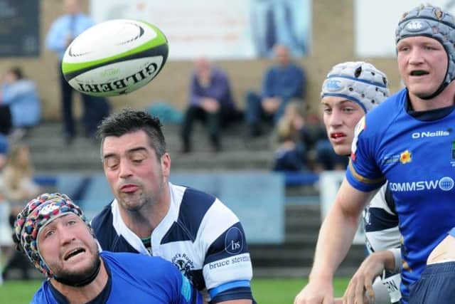 Boroughmuirs Johnny Adams is tackled by Graham Wilson. Picture: Lisa Ferguson