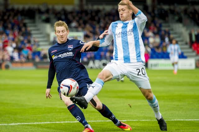 Goalscorer Michael Gardyne goes up against James McAlister in Dingwall. Picture: SNS