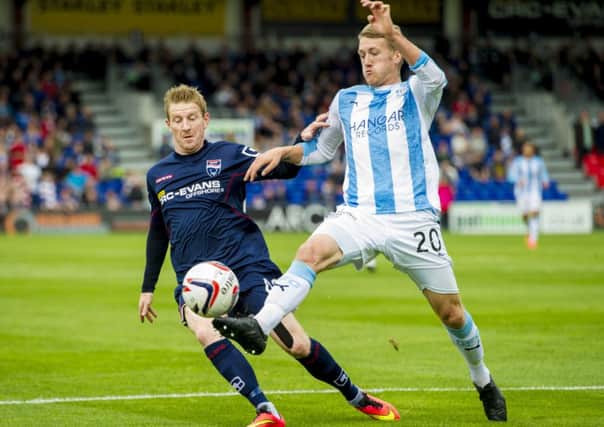 Goalscorer Michael Gardyne goes up against James McAlister in Dingwall. Picture: SNS