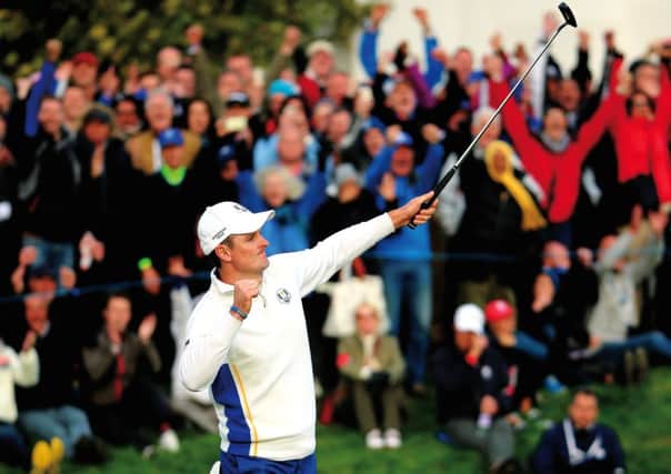 Justin Rose celebrates as he halves his match on the 18th green during the Afternoon Foursomes of the 2014 Ryder Cup. Picture: Getty