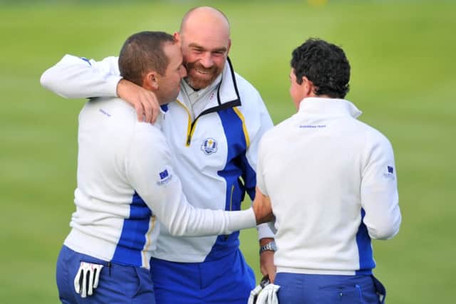Thomas Bjorn congratulates Sergio Garcia and Rory McIlroy after winning their foursomes match. Picture: AFP