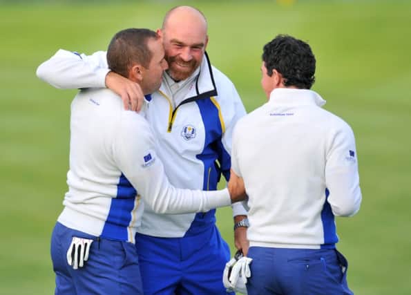Thomas Bjorn congratulates Sergio Garcia and Rory McIlroy after winning their foursomes match. Picture: AFP