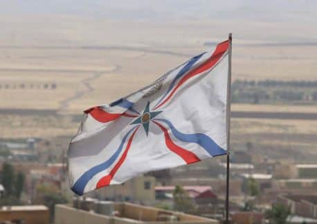 The Iraqi Christian Assyrian flag flutters over the town of al-Qosh, 45 kilometres north of Mosul. Picture: Getty