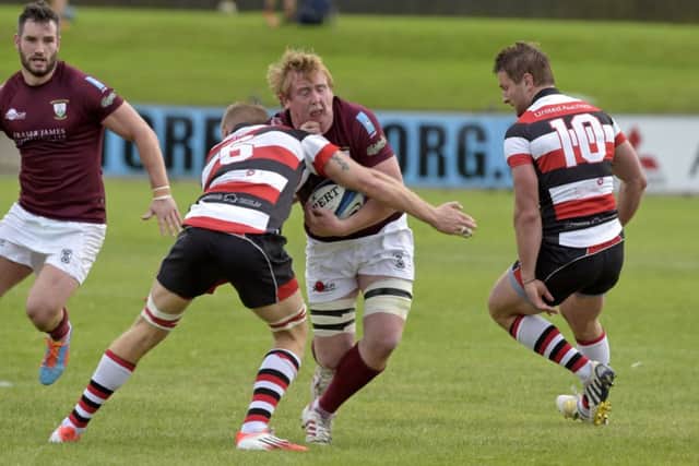 Euan Dods of Gala is engulfed by Stirling Captain Struan Robertson. Picture: Rob Gray