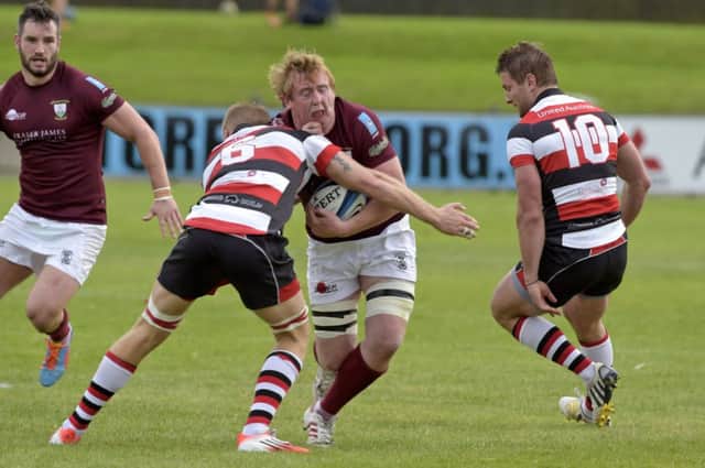 Euan Dods of Gala is engulfed by Stirling Captain Struan Robertson. Picture: Rob Gray