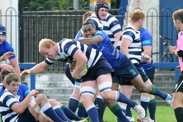 Heriots back rower Jason Hill is held by Boroughmuir winger Apenai Kororua. Picture: Lisa Ferguson