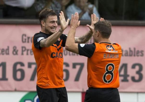 Paul Paton is high-fived by midfield partner John Rankin. Picture: SNS