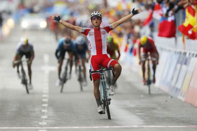 Polands Michal Kwiatkofski celebrates as he crosses the finish line to win. Picture: AP